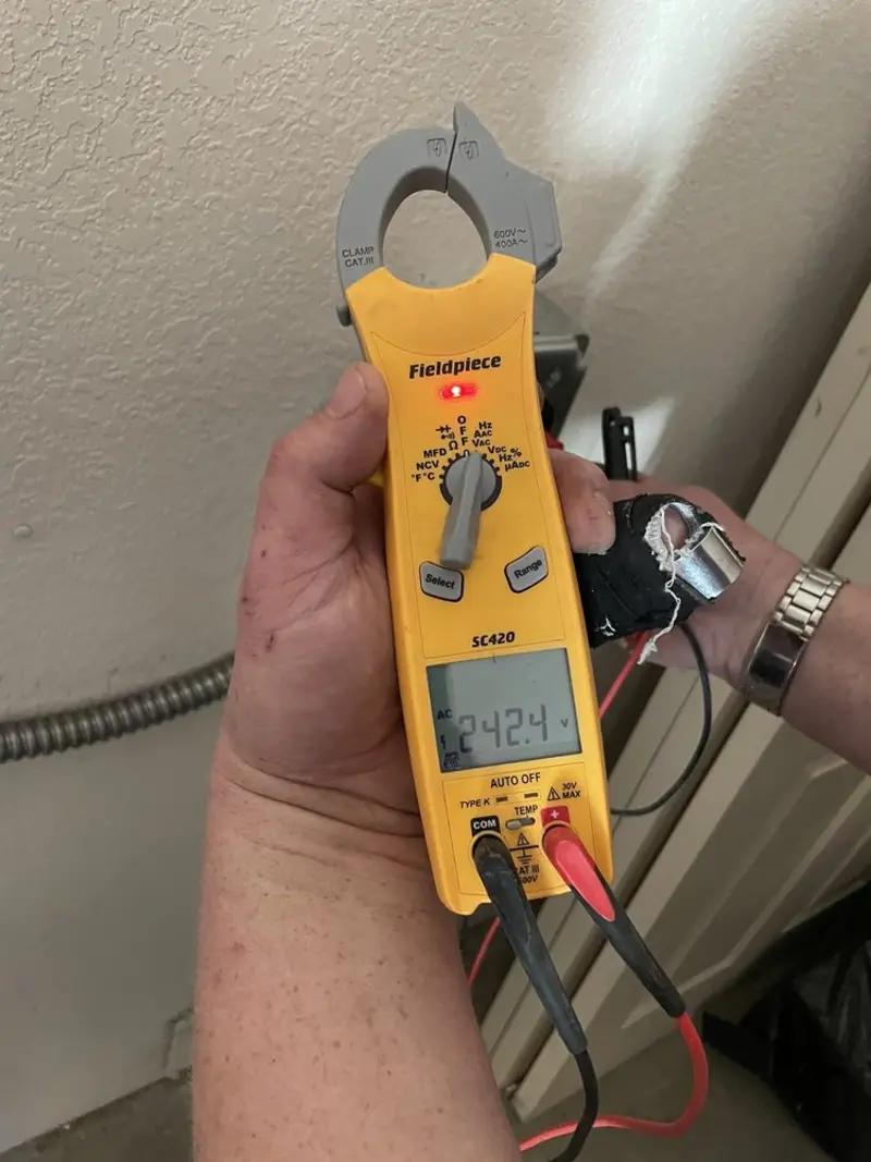 Voltage testing with clamp meter during Outlet Installation in Denison
